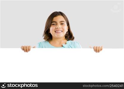 Young girl holding and showing something on a whiteboard