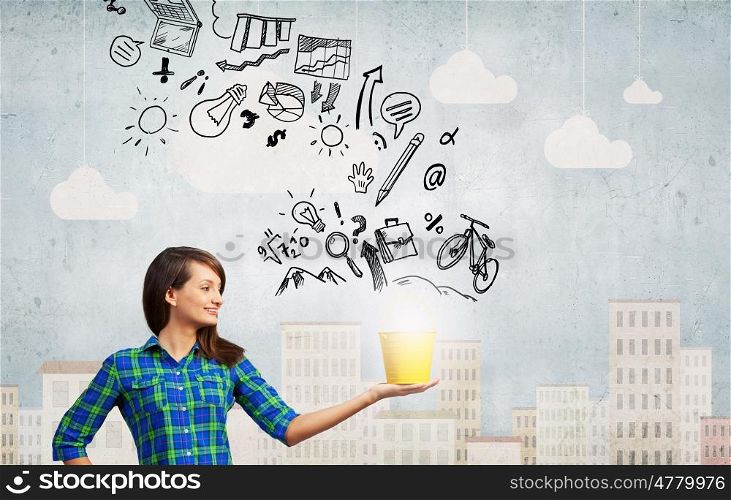 Young girl holding bucket with flying out sketches