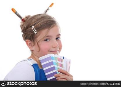 Young girl holding colour samples