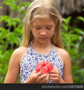 Young girl holding flower at Moorea in Tahiti