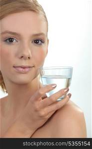 young girl holding glass of water