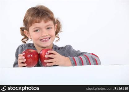 Young girl holding Red Delicious apples