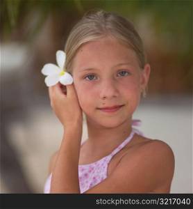 Young Girl Holding White Flower in Her Hair at Moorea in Tahiti