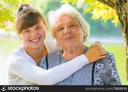 young girl hugging her beloved grandmother