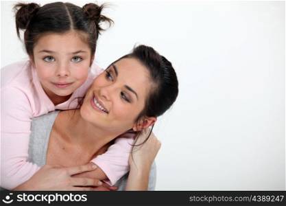 Young girl hugging her mother