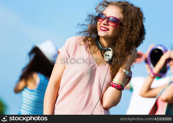 Young girl. Image of young attractive woman with friends at background