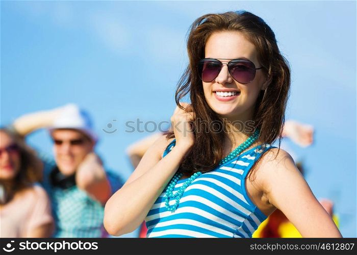 Young girl. Image of young attractive woman with friends at background