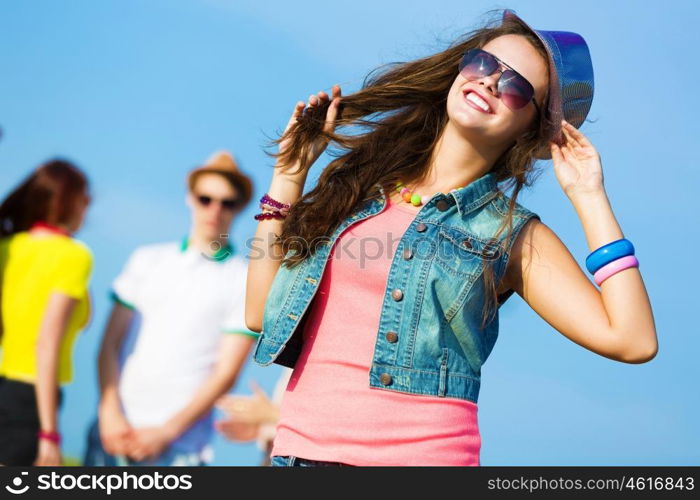 Young girl. Image of young attractive woman with friends at background