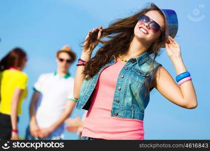 Young girl. Image of young attractive woman with friends at background