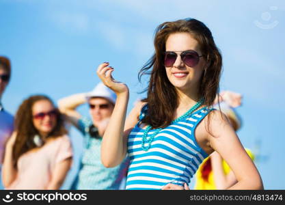 Young girl. Image of young attractive woman with friends at background