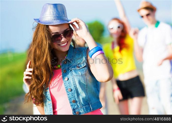 Young girl. Image of young attractive woman with friends at background