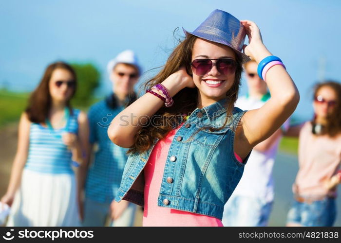 Young girl. Image of young attractive woman with friends at background