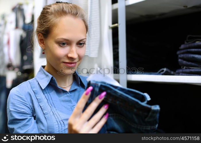 Young girl in a shop buying clothes