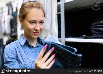 Young girl in a shop buying clothes