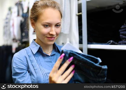 Young girl in a shop buying clothes