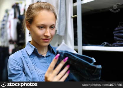 Young girl in a shop buying clothes