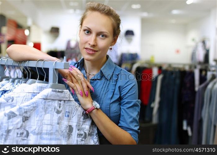 Young girl in a shop buying clothes