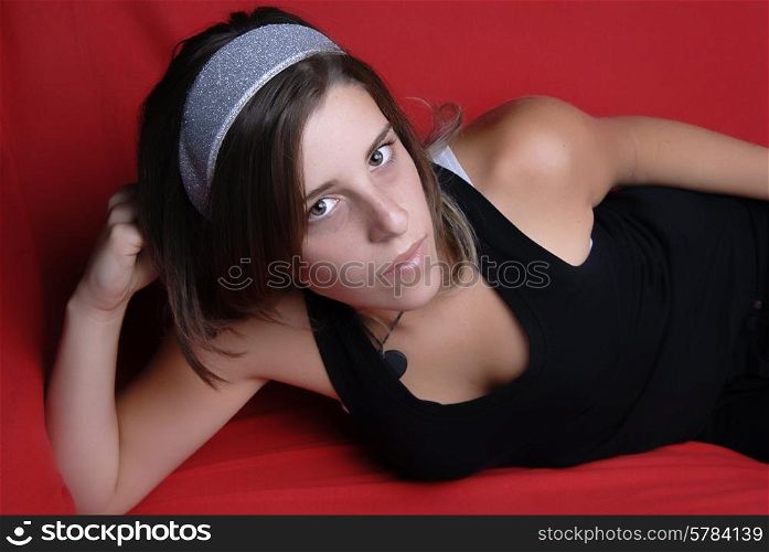 young girl in a sofa, studio picture