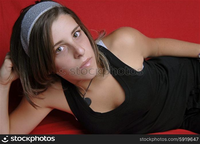 young girl in a sofa, studio picture