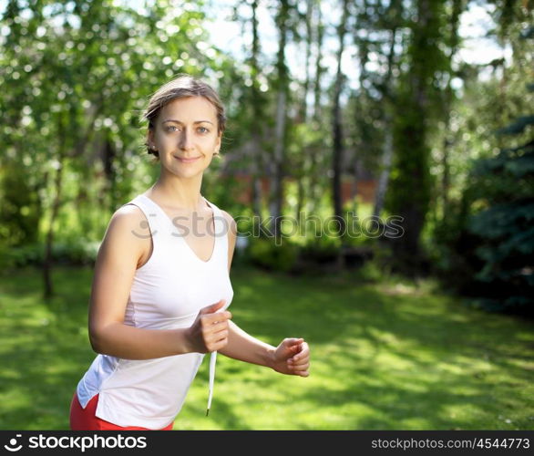 Young girl in a white shirt and red pants likes to run outdoors.