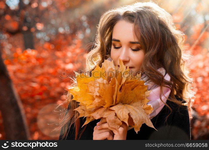 Young girl in autumn forest