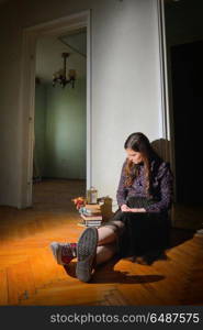 Young girl in black vintage dress in empty house