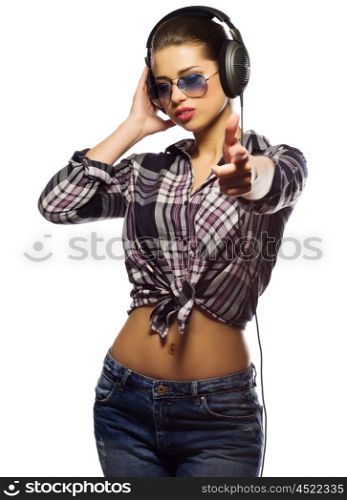 Young girl in blue jeans with headphones isolated