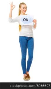 "Young girl in blue jeans with "Ok" placard isolated"