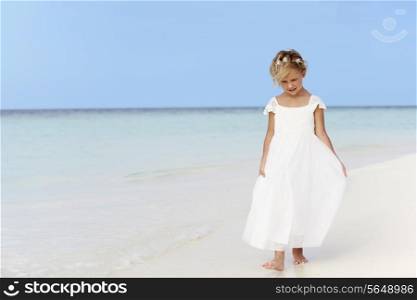 Young Girl In Bridesmaid Dress Walking On Beautiful Beach