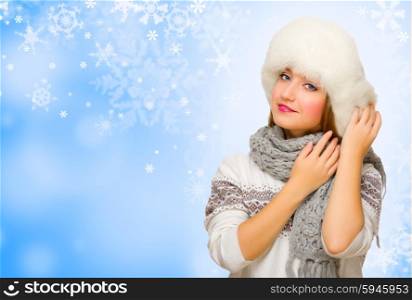 Young girl in fur hat on blue winter backgrond