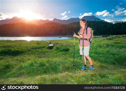Young girl in hike near like mountain in the summer