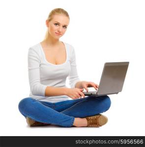 Young girl in jeans with laptop isolated
