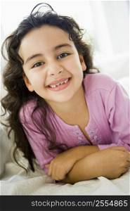 Young girl in living room smiling (high key)
