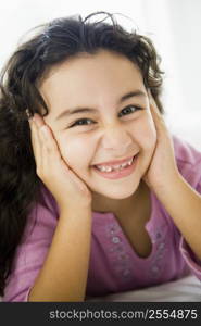 Young girl in living room smiling (high key/selective focus)