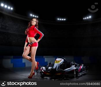 Young girl in red racing costume at stadium