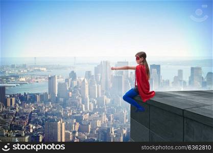 Young girl in superhero costume overlooking the city. The young girl in superhero costume overlooking the city