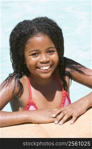Young girl in swimming pool smiling