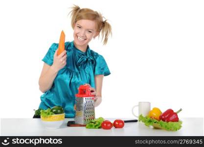 young girl in the kitchen rubbing carrots. Isolated on white background