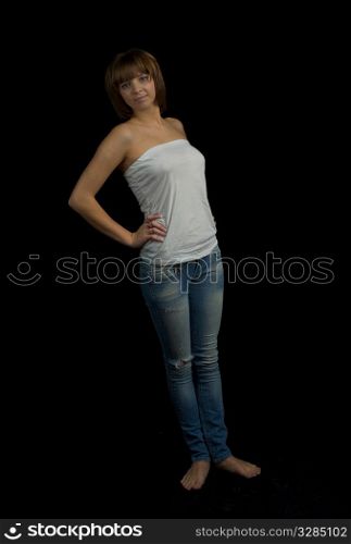 young girl in white t-shirt and jeans on black