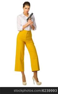 Young girl in yellow pants with gun isolated