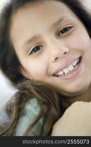 Young girl indoors smiling (high key)