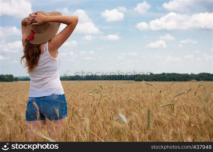 young girl joys on the wheat field