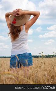 young girl joys on the wheat field