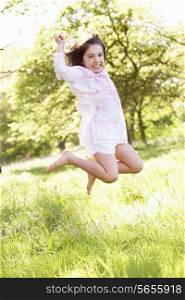 Young Girl Jumping In Summer Field