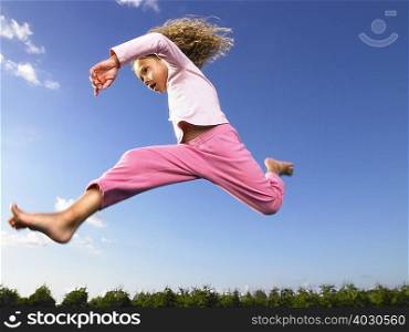Young girl jumping in the air