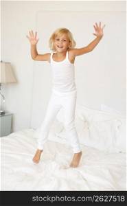 Young Girl Jumping On Bed