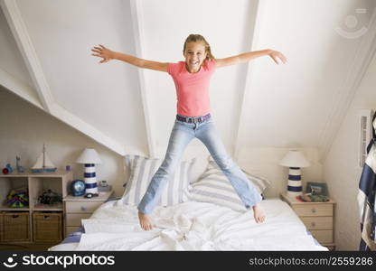 Young Girl Jumping On Her Bed