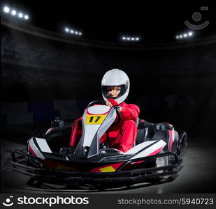 Young girl karting driver at sports hall