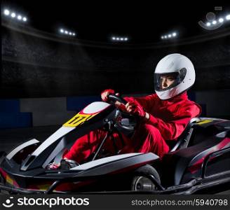 Young girl karting racer at stadium