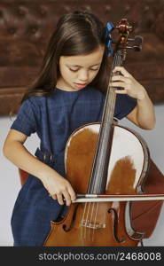 young girl learning how play cello